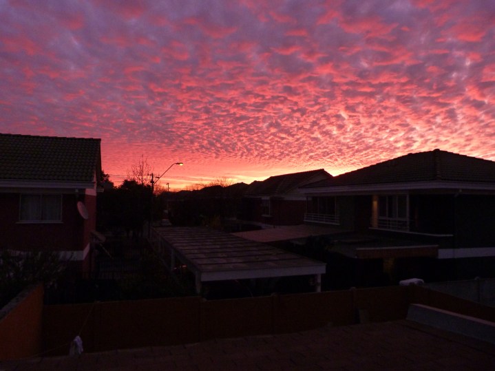 Softly drops the crimson sun:   Softly down from overhead, Drop the bell-notes, one by one,   Melting in the melting red;